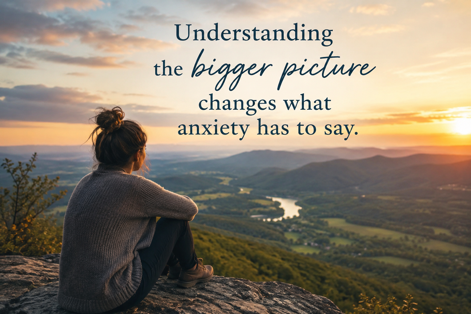 Woman looking out over mountain vista at sunrise